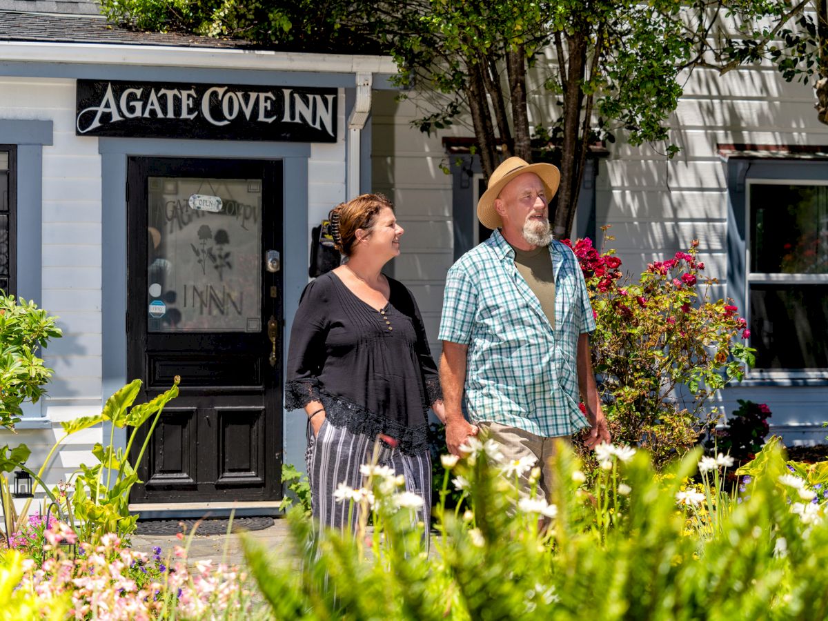 A man and woman are standing outside a building with a sign that reads 